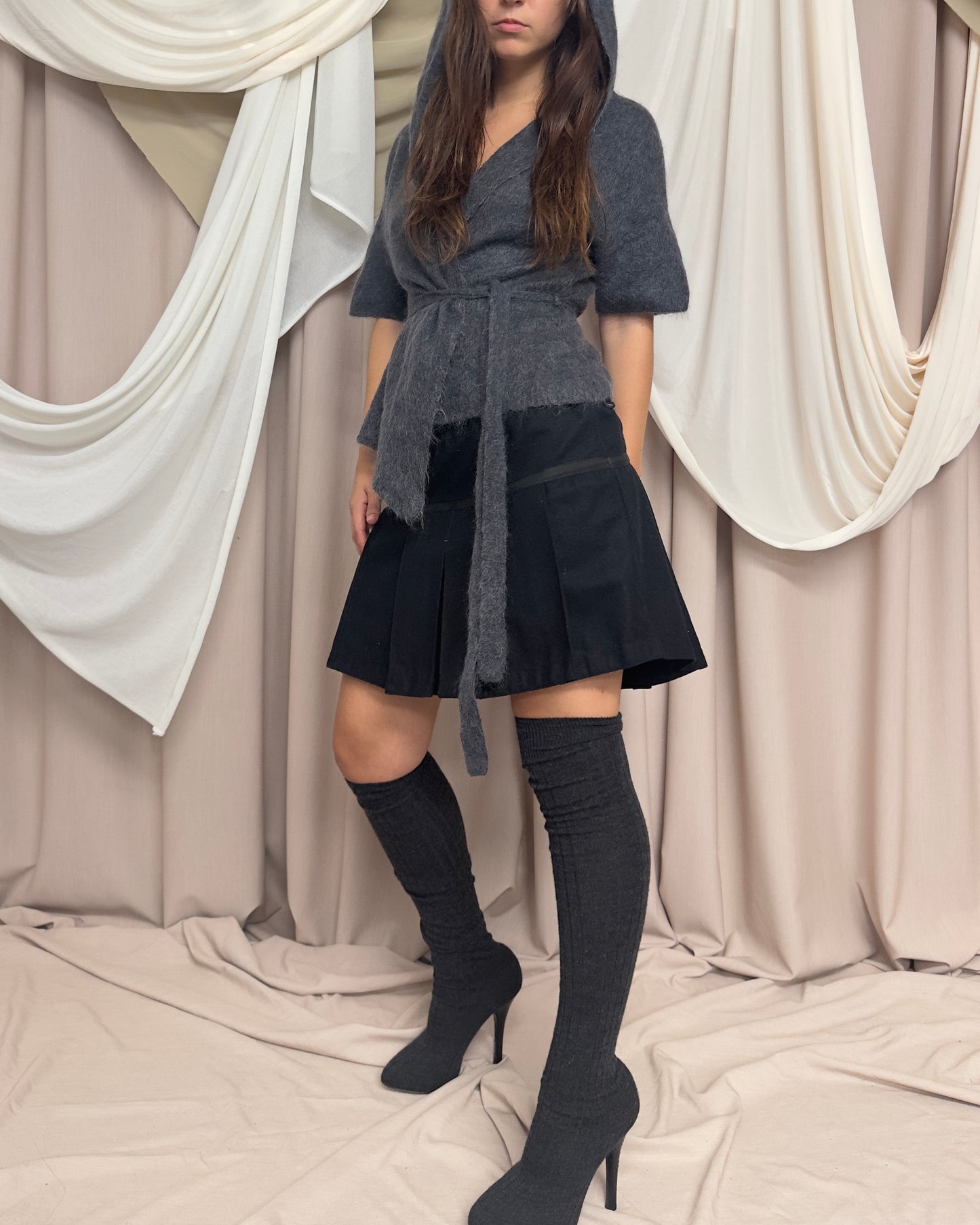 BLACK WOOL PLEATED MINI SKIRT WITH CROSS FRONT DETAIL by Maharishi
