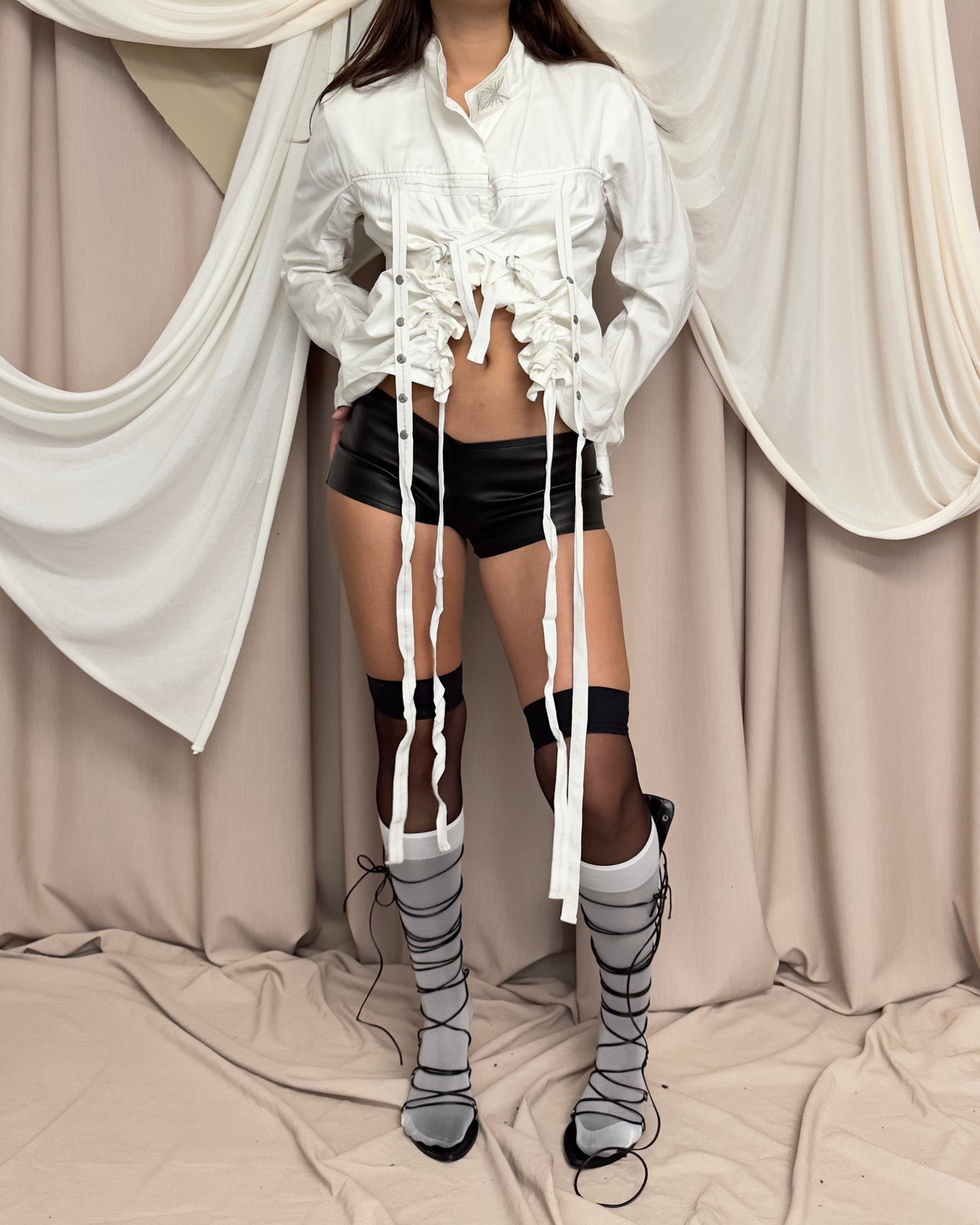 WHITE SHIRT WITH ASYMMETRICAL HEM AND UTILITARIAN STRAPS by Marithé + François Girbaud