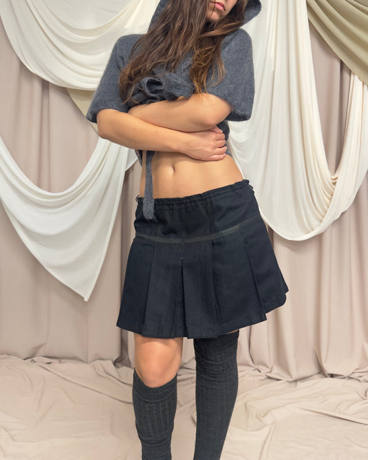 BLACK WOOL PLEATED MINI SKIRT WITH CROSS FRONT DETAIL by Maharishi