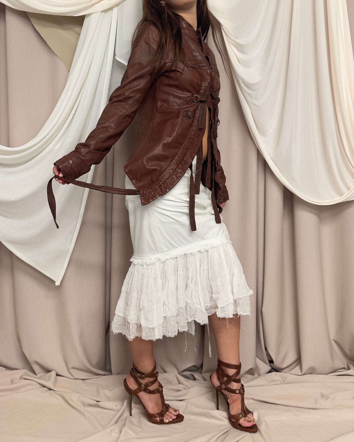 RUST LEATHER 'BONDAGE' JACKET WITH ASYMMETRICAL HEM AND UTILITARIAN STRAPS by Marithé + François Girbaud