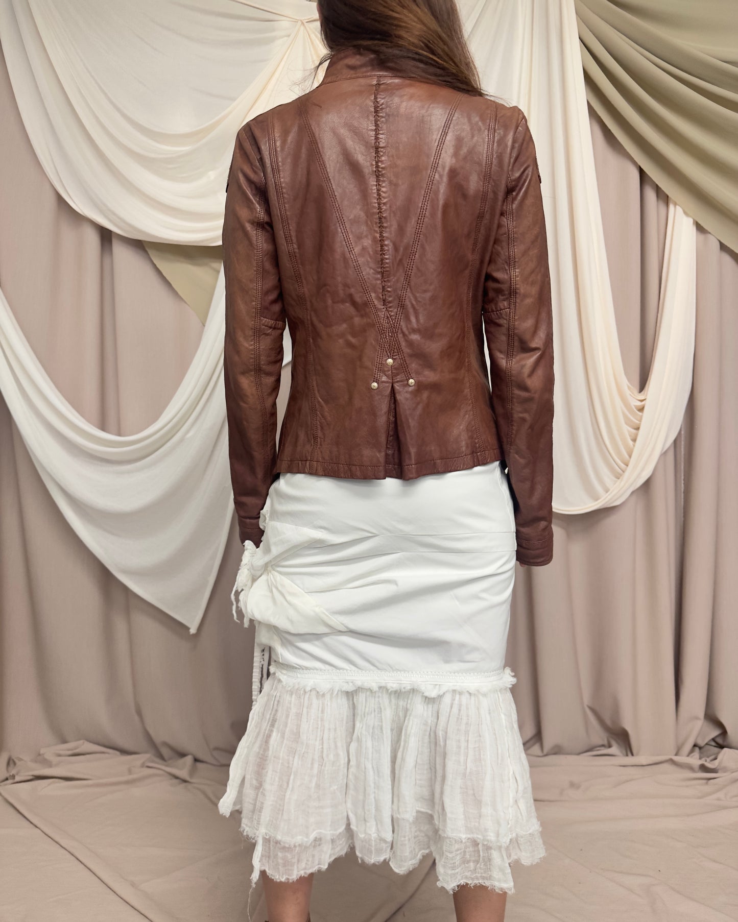 RUST LEATHER 'BONDAGE' JACKET WITH ASYMMETRICAL HEM AND UTILITARIAN STRAPS by Marithé + François Girbaud