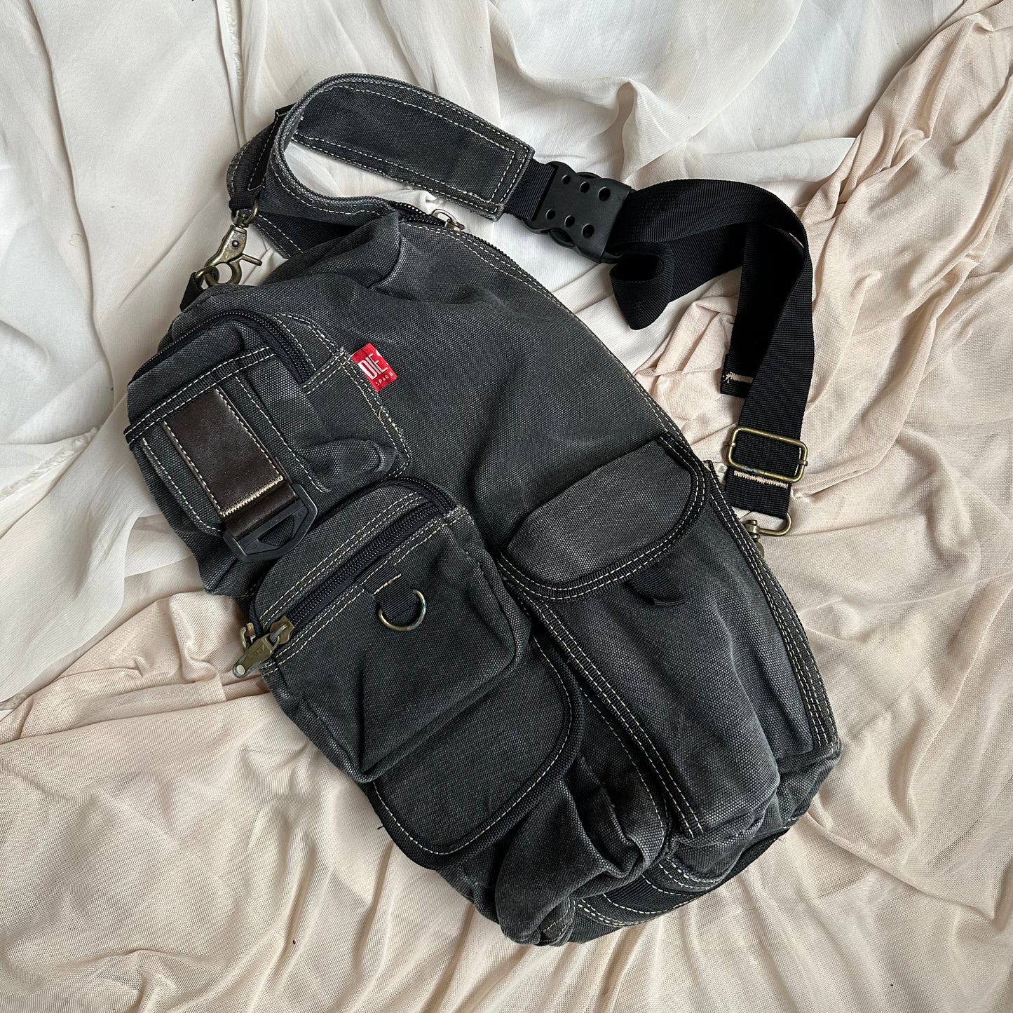 MULTI-POCKET CANVAS SLING BAG IN CHARCOAL by Diesel Red Tag