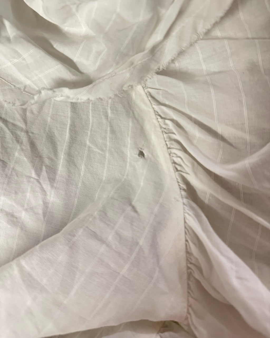 WHITE VEST WITH DISTRESSED RUFFLED PANEL